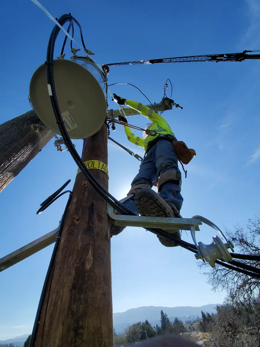 Lineman climbing a wood pole