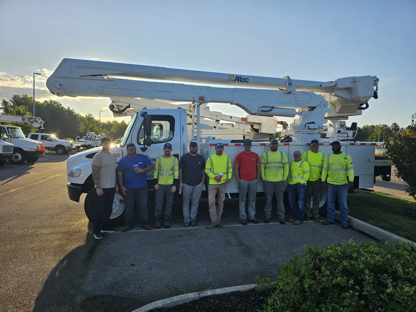 Line crew standing in front of a bucket truck