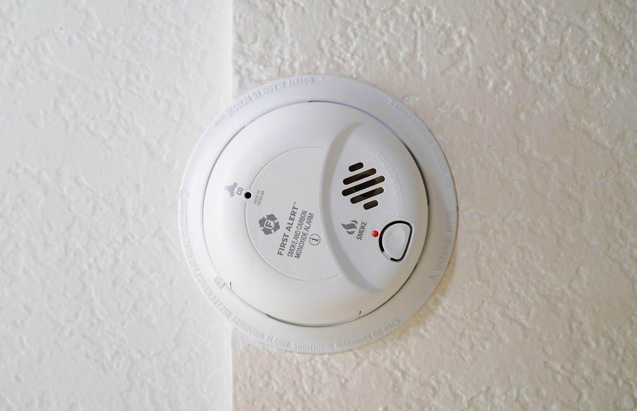 Carbon monoxide and smoke combination alarm on a wall