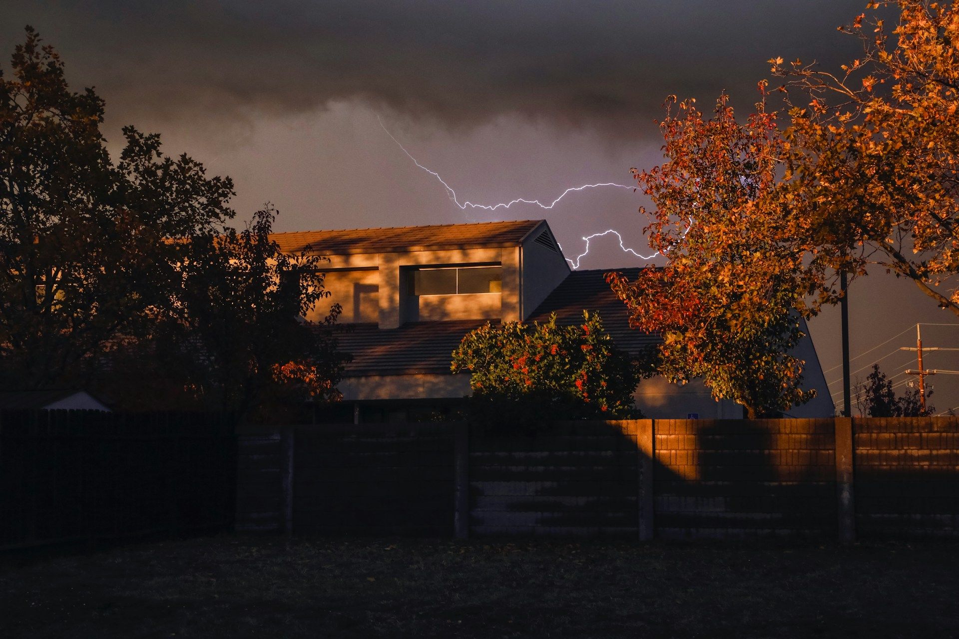 Dark home in a storm with lightning
